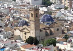 Oliva's two blue roof domed churches are lit up at night. Property in Oliva.